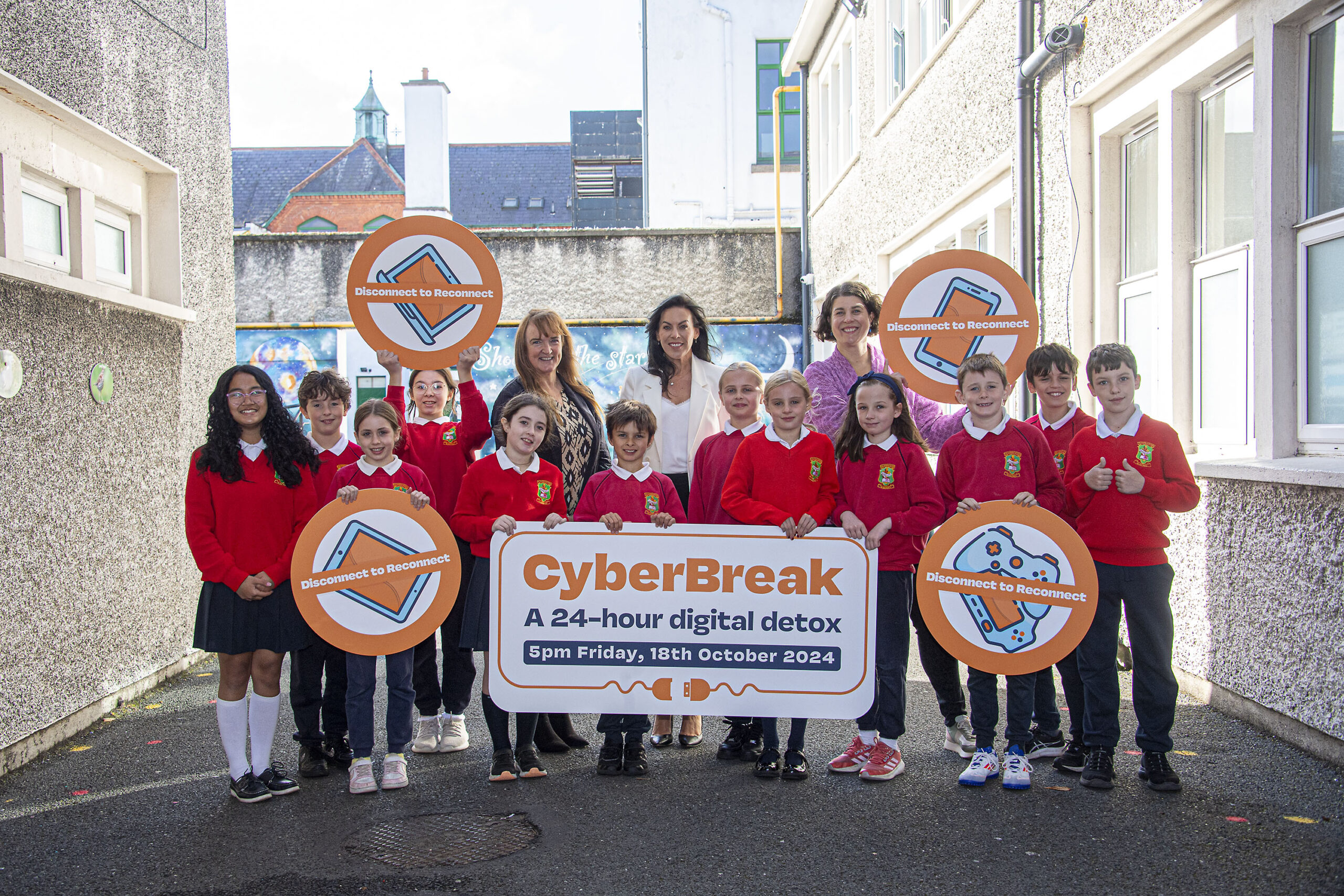 CyberBreak launch with children promoting keeping kids safe online and taking a 24-hour digital detox. Kids in red and black uniforms stand holding signs advertising the CyberBreak digital detox